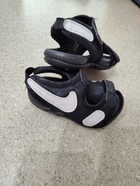Nike Kids Black Sandals with White Swoosh Accents